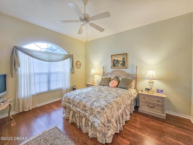 bedroom with dark hardwood / wood-style floors and ceiling fan