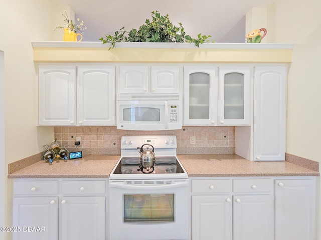 kitchen featuring white cabinetry, white appliances, and decorative backsplash