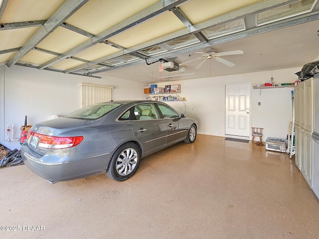 garage with a garage door opener and ceiling fan