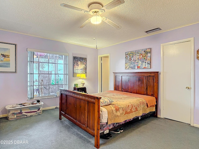 bedroom featuring visible vents, a textured ceiling, carpet, crown molding, and ceiling fan