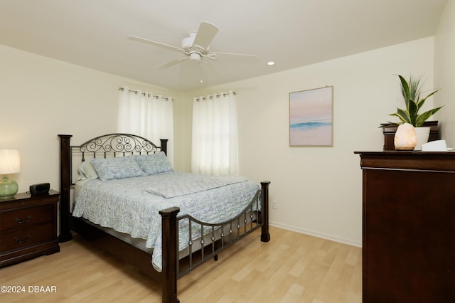 bedroom with ceiling fan and light hardwood / wood-style flooring