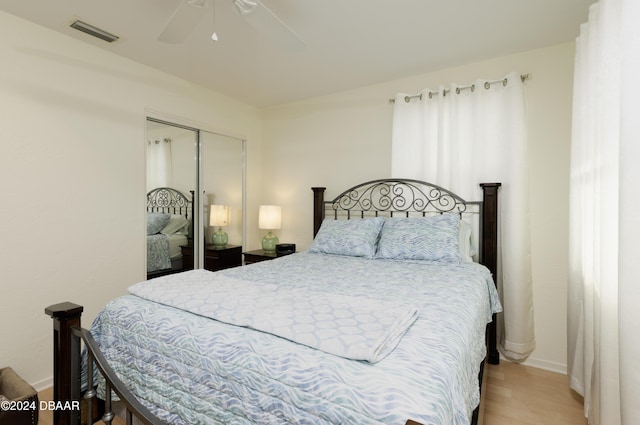 bedroom featuring light hardwood / wood-style flooring, a closet, and ceiling fan