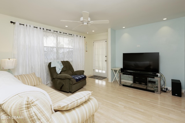 living room featuring ceiling fan and light wood-type flooring