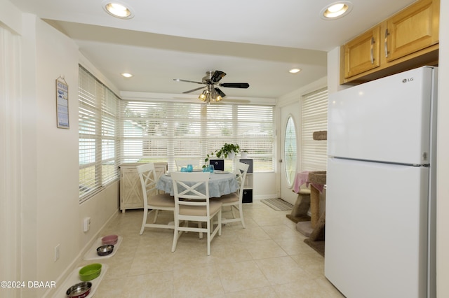 tiled dining space with ceiling fan