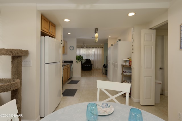 kitchen featuring light tile patterned floors and white refrigerator