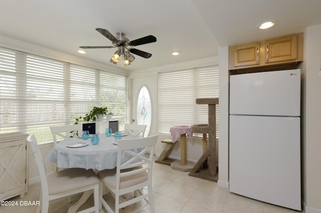 tiled dining room featuring ceiling fan