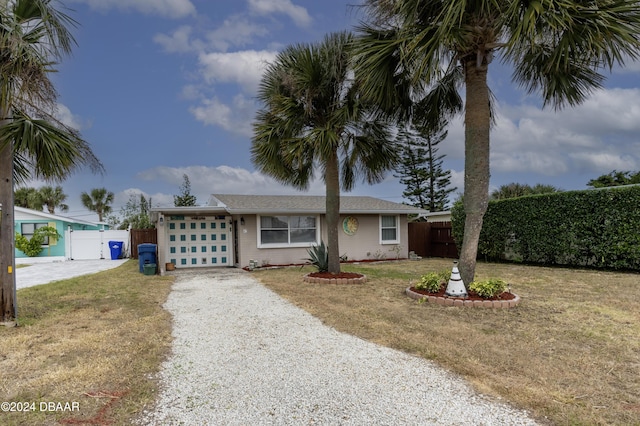 ranch-style home featuring a front yard