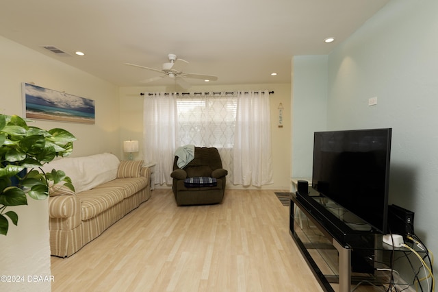 living room with ceiling fan and light wood-type flooring