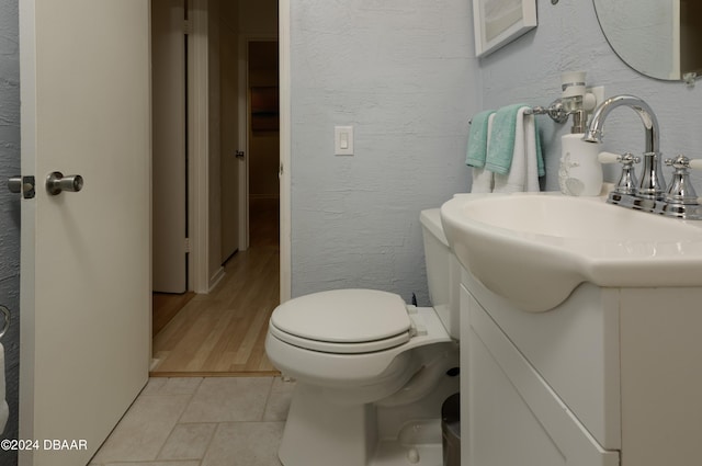 bathroom featuring hardwood / wood-style flooring, vanity, and toilet