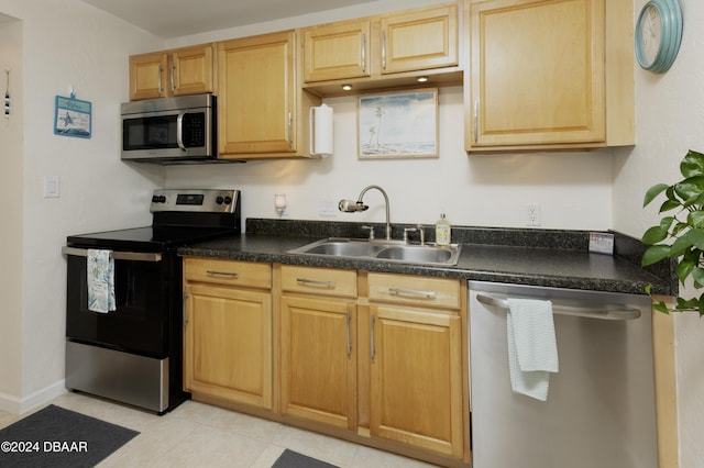 kitchen featuring light tile patterned floors, sink, and appliances with stainless steel finishes