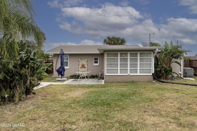 back of property featuring a yard, a patio, and central air condition unit