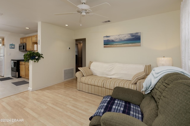 living room with light wood-type flooring and ceiling fan