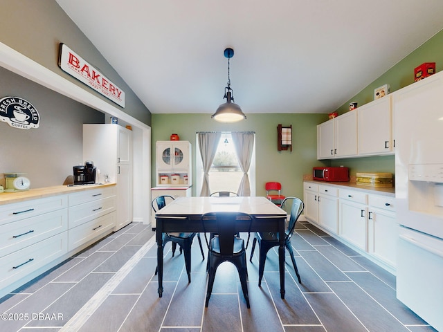 dining space featuring lofted ceiling