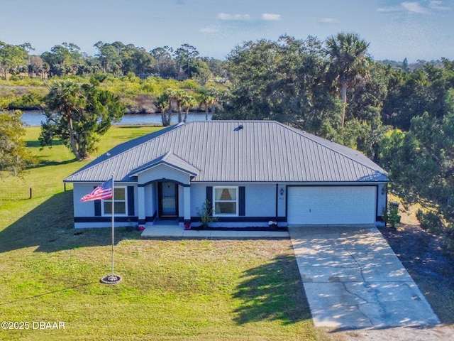 view of front facade featuring a front yard, a garage, and a water view