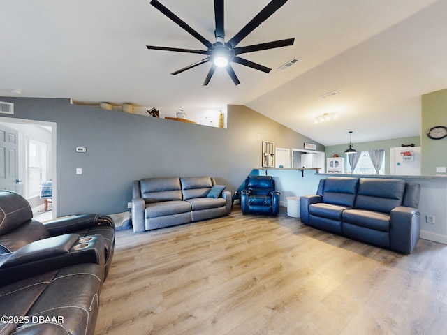 living room with ceiling fan, light hardwood / wood-style flooring, and vaulted ceiling