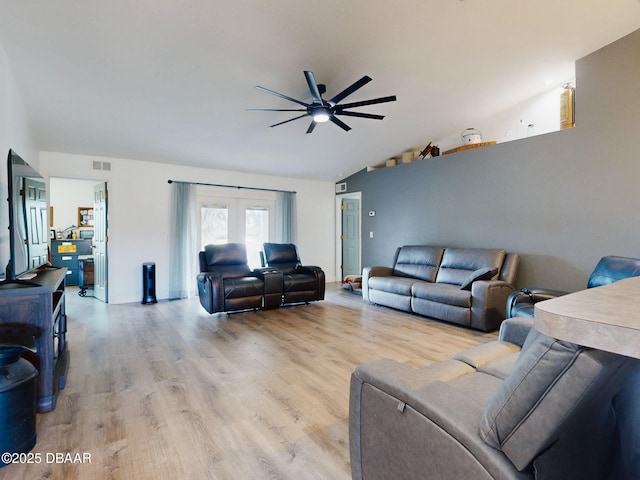 living room with vaulted ceiling, ceiling fan, light hardwood / wood-style flooring, and french doors