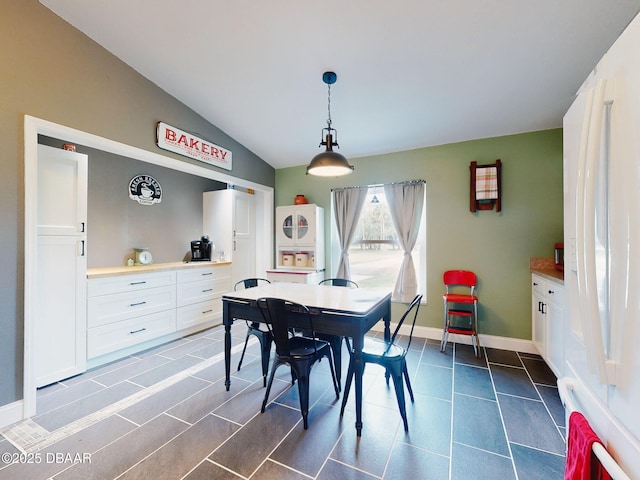 dining space with lofted ceiling