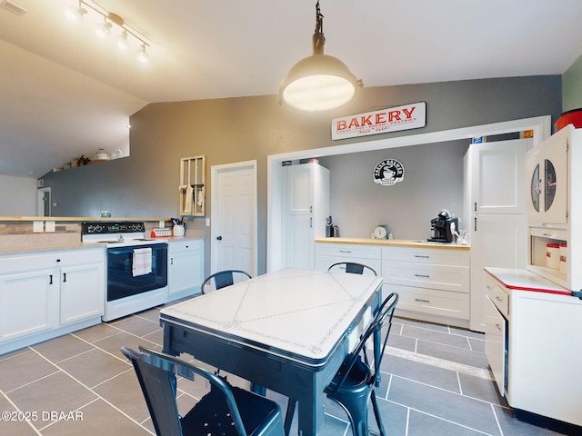 kitchen with vaulted ceiling, white cabinetry, white electric range oven, and decorative light fixtures