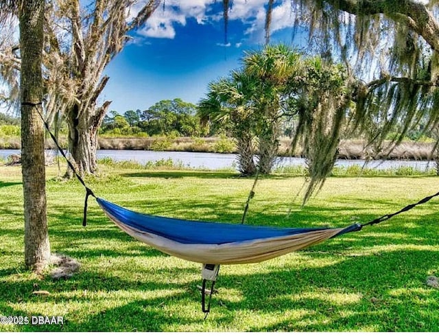 view of community with a lawn and a water view