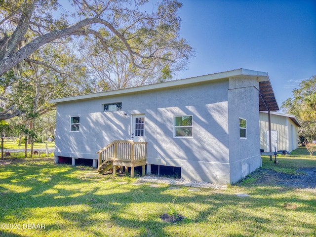 back of property featuring a lawn