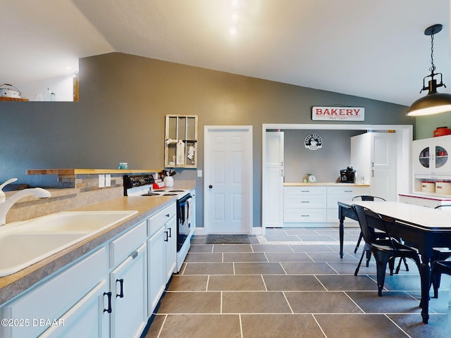 kitchen featuring lofted ceiling, white cabinetry, white electric stove, sink, and hanging light fixtures