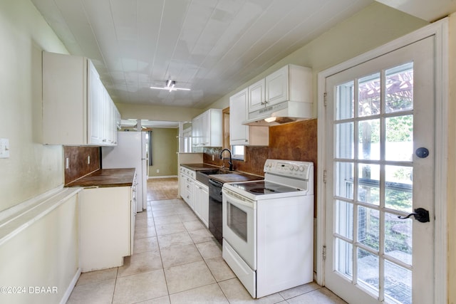 kitchen with light tile patterned flooring, sink, white appliances, white cabinets, and decorative backsplash