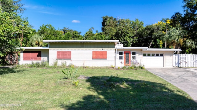 view of front of house with a garage and a front yard