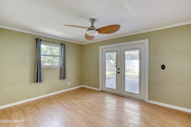 spare room featuring french doors, light hardwood / wood-style floors, ceiling fan, and crown molding