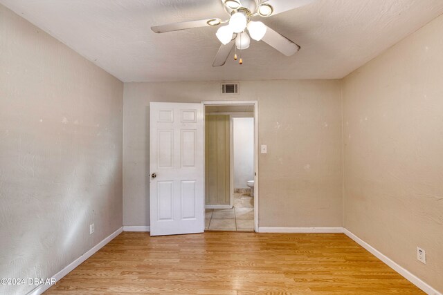 unfurnished bedroom with light hardwood / wood-style floors and ceiling fan