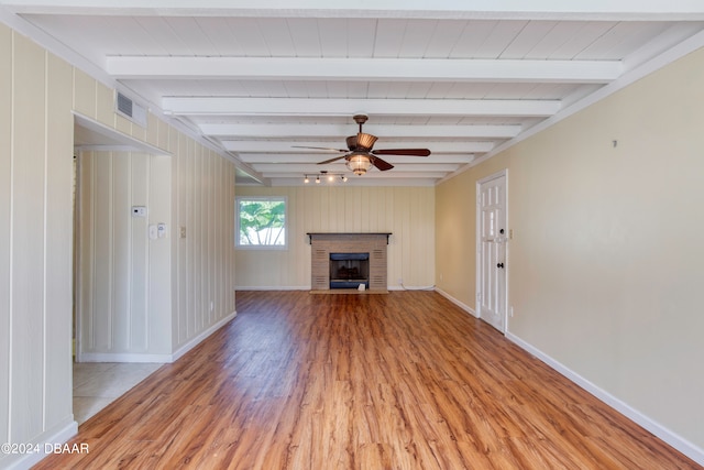 unfurnished living room with light wood-type flooring, beamed ceiling, and ceiling fan