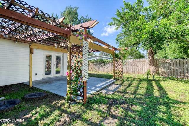 view of yard with french doors, a pergola, and a patio