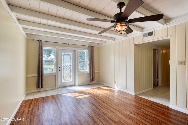 unfurnished room featuring light wood-type flooring, beamed ceiling, ceiling fan, and wood ceiling