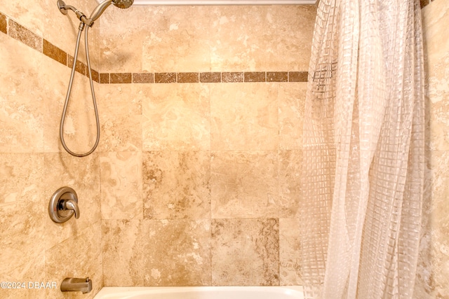 room details featuring shower / bath combination with curtain