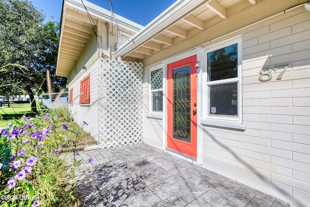 entrance to property featuring a patio