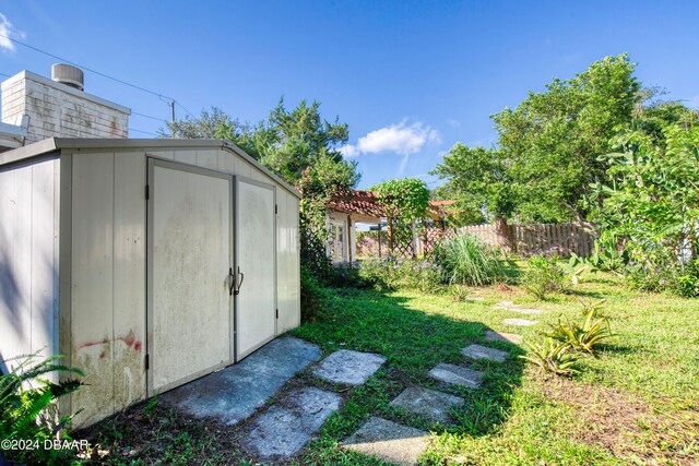 view of outbuilding featuring a lawn