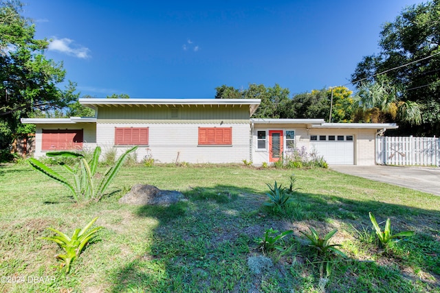 ranch-style house with a garage and a front yard