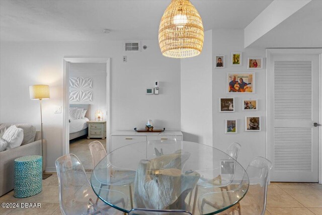 tiled dining area featuring an inviting chandelier