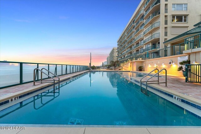 view of pool at dusk