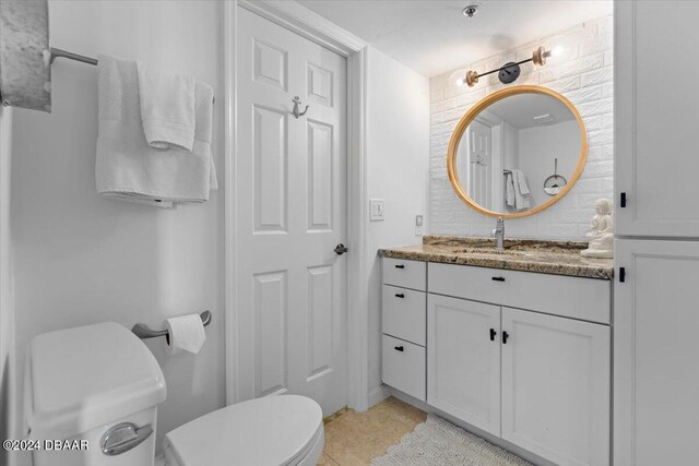 bathroom with tile patterned floors, vanity, and toilet