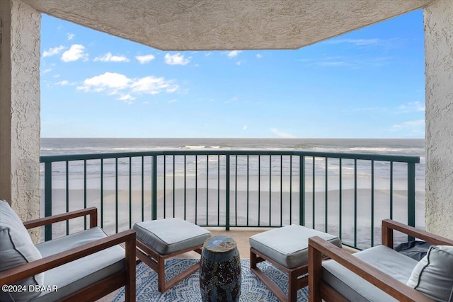 balcony with a beach view and a water view