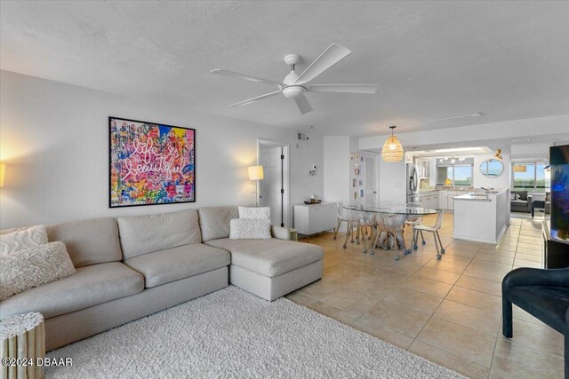 living room with ceiling fan and light tile patterned floors