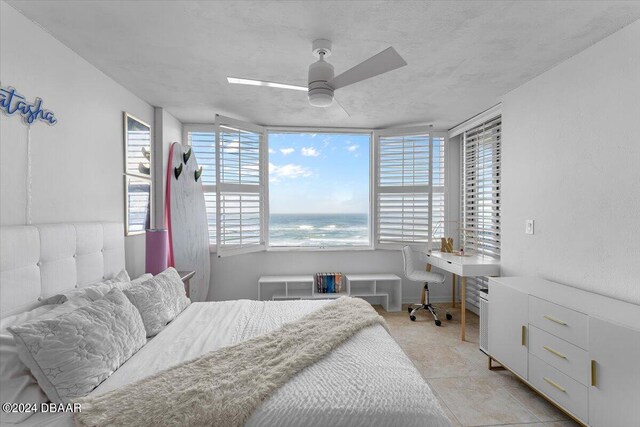 bedroom with light tile patterned flooring, a textured ceiling, and ceiling fan