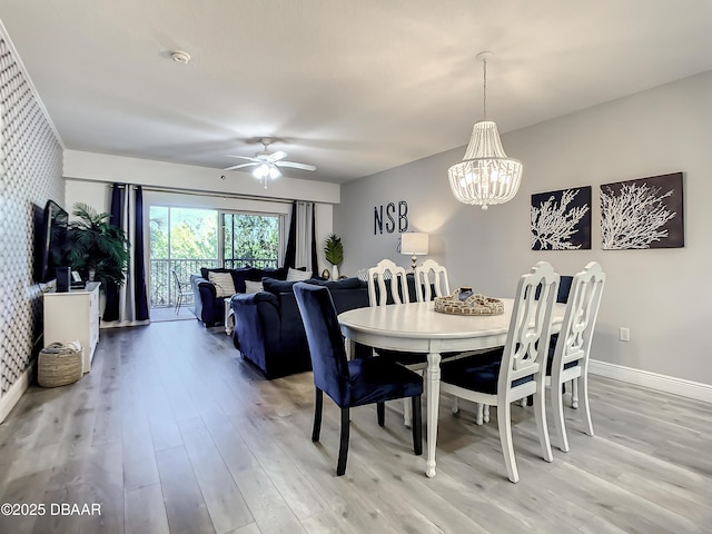 5300 S Atlantic Ave Unit 10-205, New Smyrna Beach, FL 32168 - dining room featuring light wood-style floors, baseboards, and ceiling fan with notable chandelier