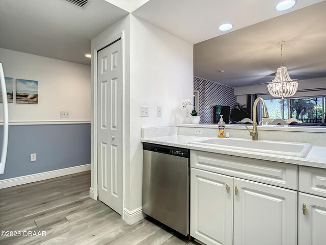 5300 S Atlantic Ave Unit 10-205, New Smyrna Beach, FL 32168 - kitchen featuring white cabinets, an inviting chandelier, dishwasher, and a sink