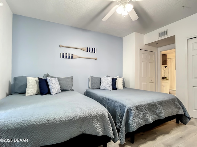 5300 S Atlantic Ave Unit 10-205, New Smyrna Beach, FL 32168 - bedroom featuring visible vents, wood finished floors, and ceiling fan
