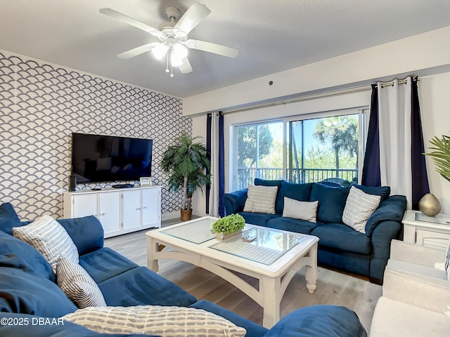 5300 S Atlantic Ave Unit 10-205, New Smyrna Beach, FL 32168 - living area featuring an accent wall, wallpapered walls, ceiling fan, and light wood-type flooring