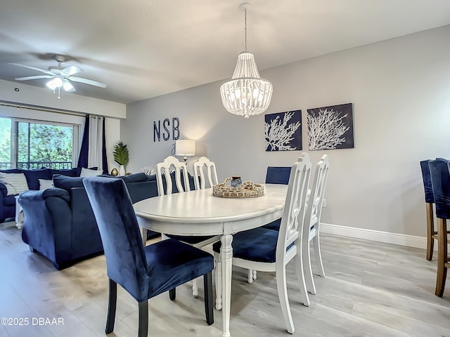 5300 S Atlantic Ave Unit 10-205, New Smyrna Beach, FL 32168 - dining room with baseboards, light wood-type flooring, and ceiling fan with notable chandelier