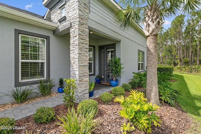 17 Newhaven Ln Unit 17, Ormond Beach, FL 32174 - doorway to property with stucco siding and a lawn