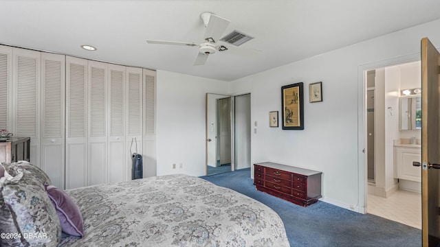 carpeted bedroom featuring ensuite bathroom, ceiling fan, and sink