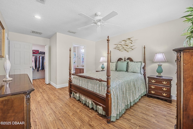 43 Pergola Pl, Ormond Beach, FL 32174 - bedroom with a textured ceiling, light wood-style floors, visible vents, and baseboards